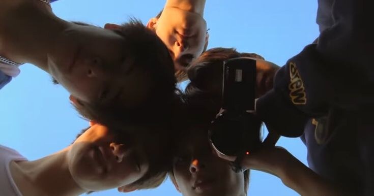 CORTIS members looking down toward the camera